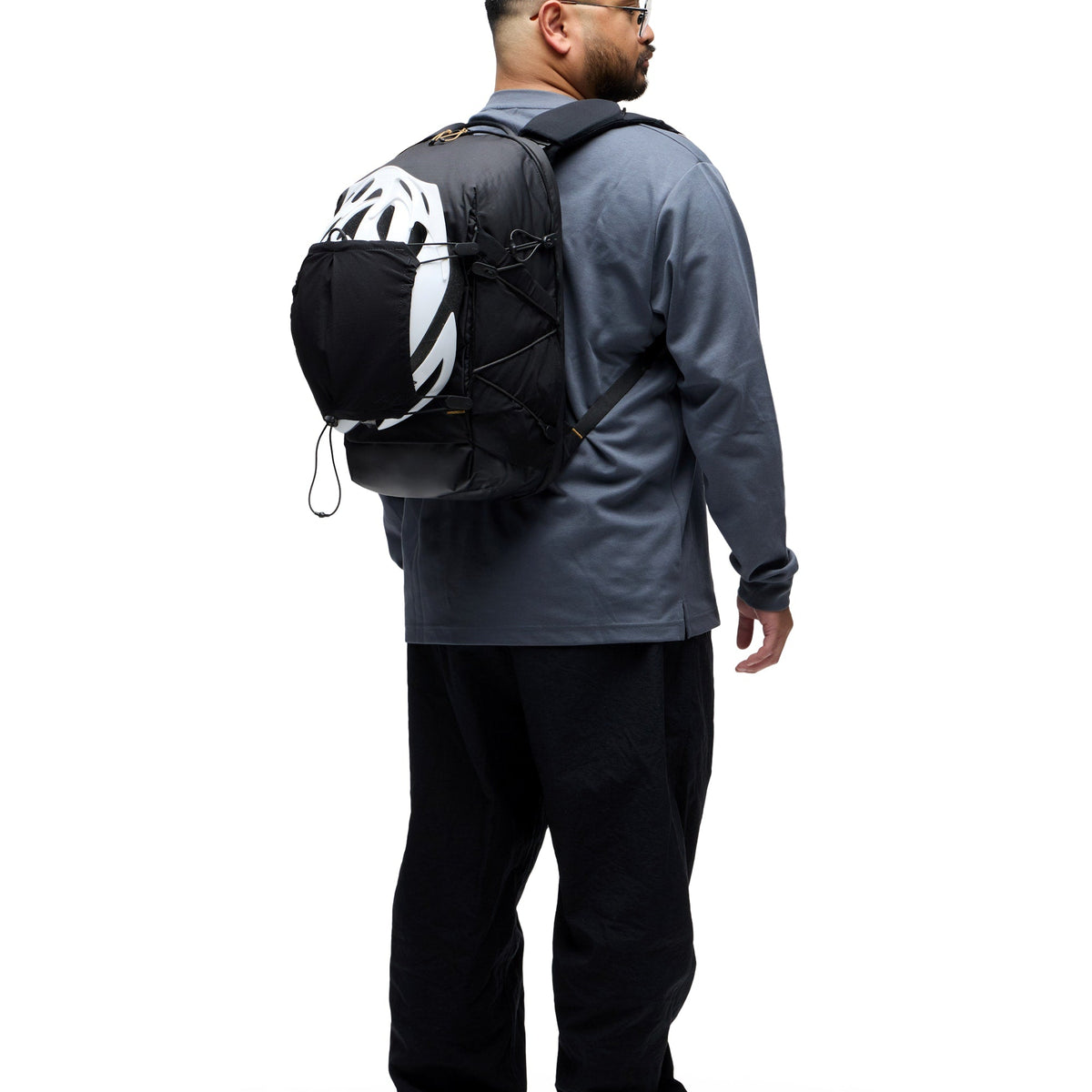 Peak Design Outdoor Helmet Carrier worn on backpack