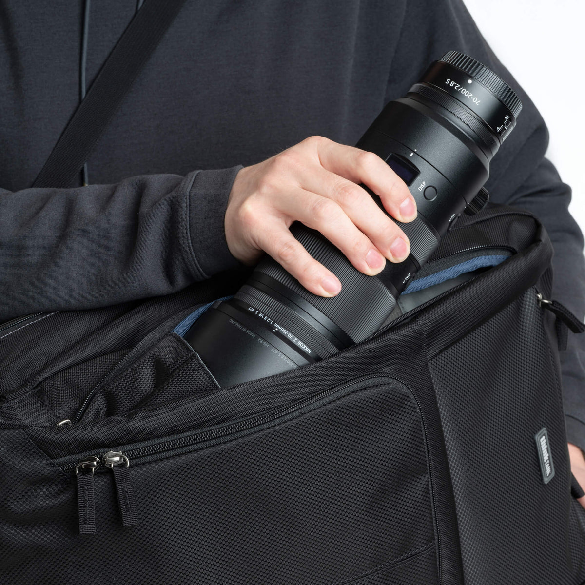 Think Tank Shape Shifter 37L quick-access front side pocket holding a 70-200mm lens